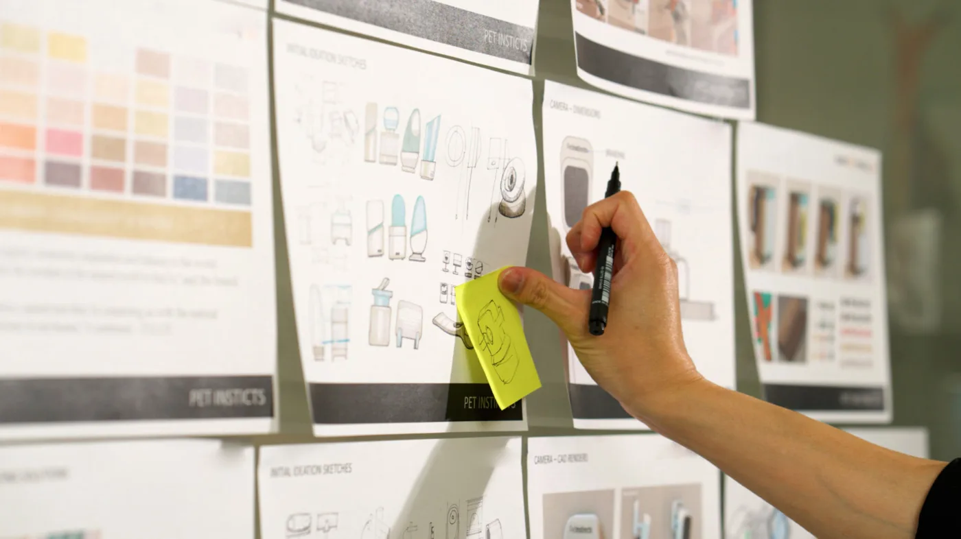 An S29 designer sketching product concepts on the studio whiteboard